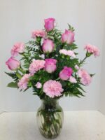 pink roses and carnations in glass vase