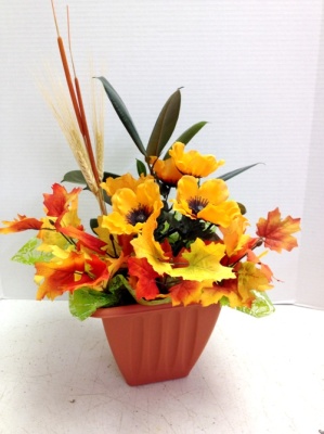 fall flower arrangement in orange pot